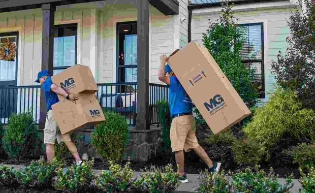 local movers carrying boxes into a home