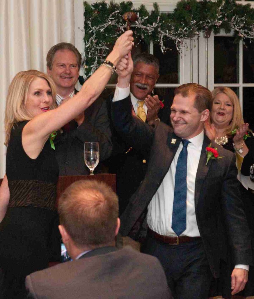 loudon charity members raising the gavel at the fundraiser