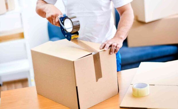 man packing a box