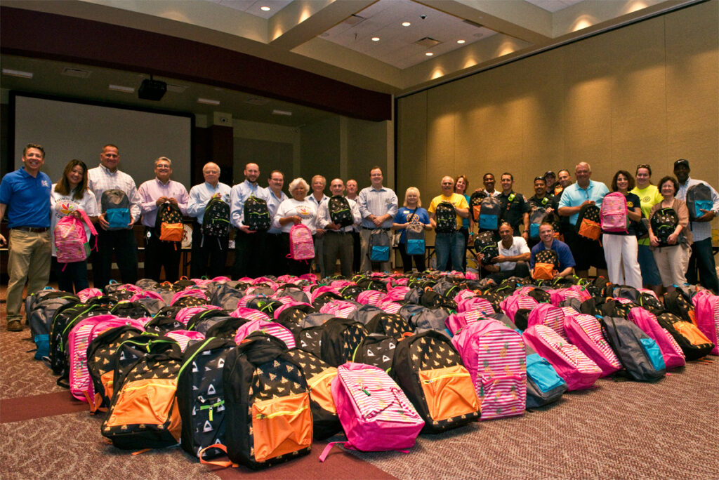 group picture with 650 backpacks