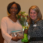 Dulles Area Association of Realtors handing flowers to a honorary member