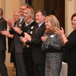 Dulles Area Association of Realtors clapping together for a member