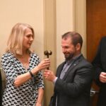 Dulles Area Association realtors passing down the award gavel
