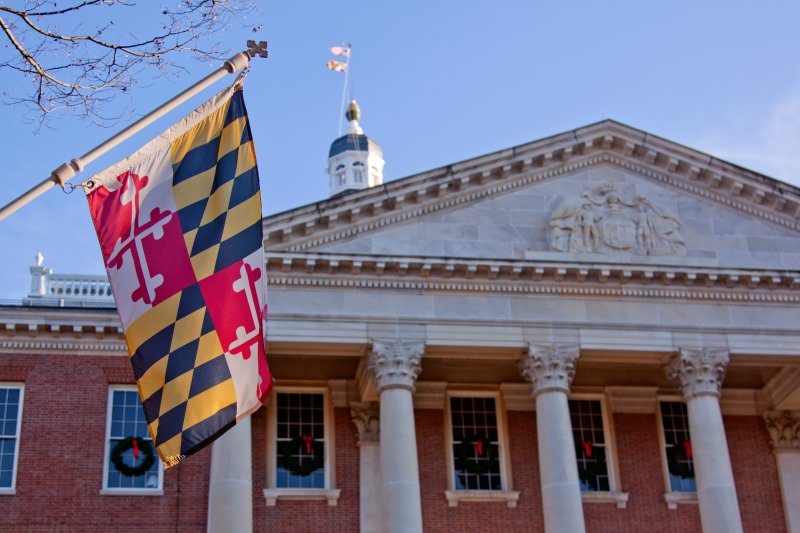 Close up view of Maryland state flag in front of the capitol state house in Annapolis MD