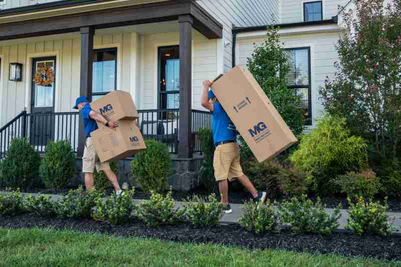 two-movers-carrying-boxes-my-guys