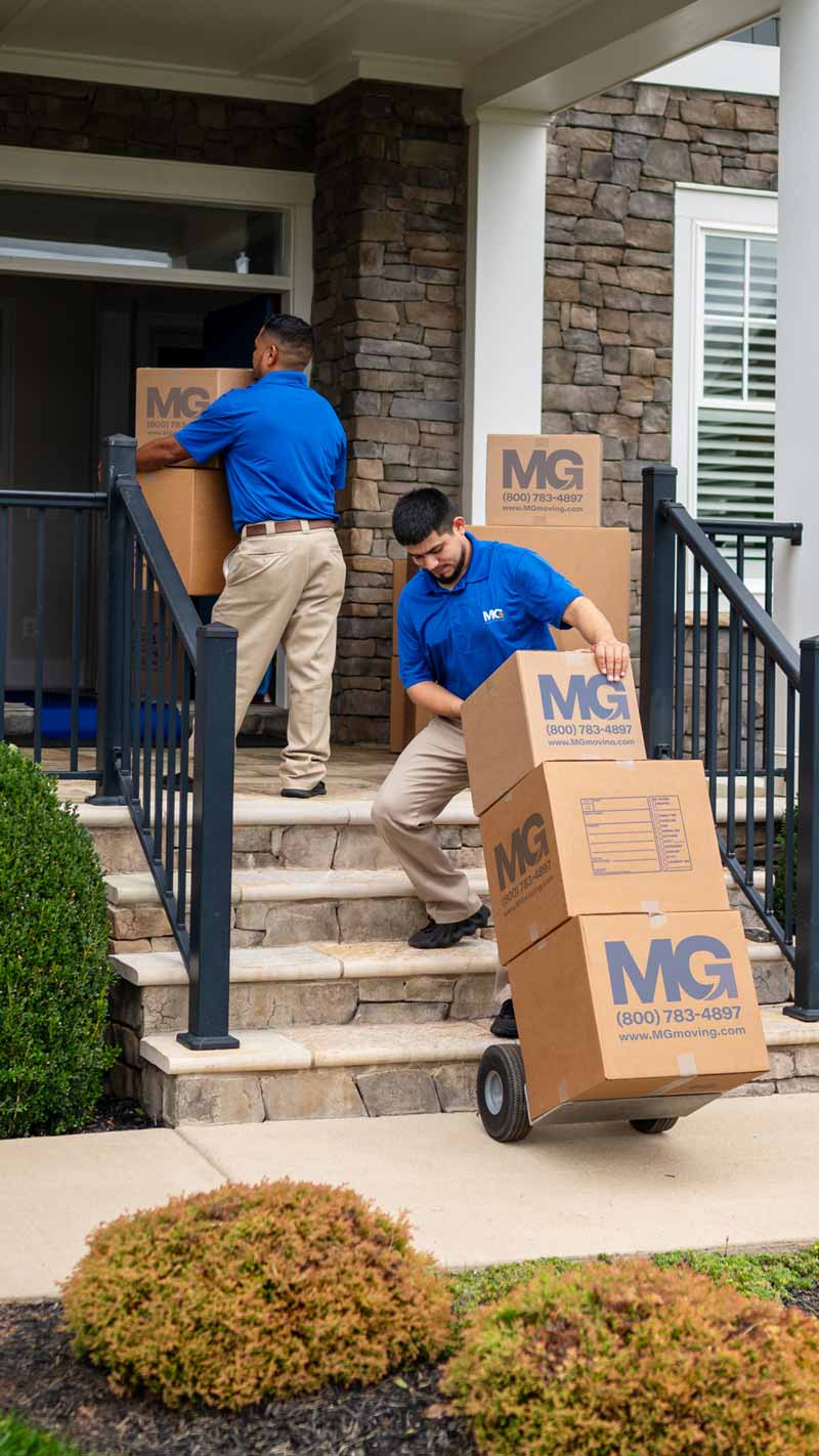 antique movers carrying boxes up stairs