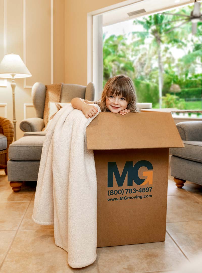girl in residential moving box