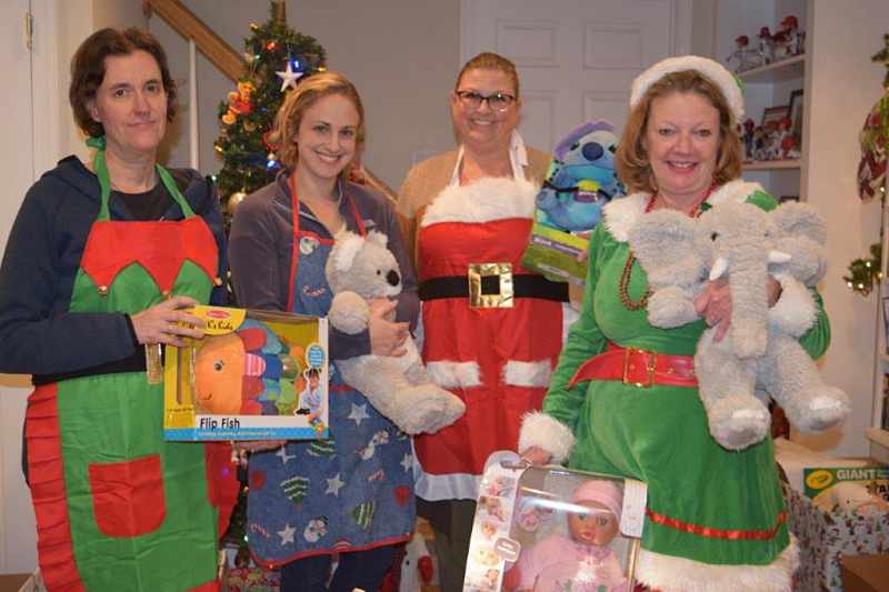 pediatric elf squad in costume and holding gifts