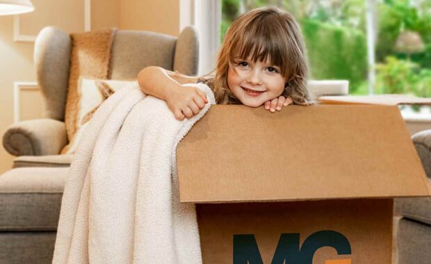 little girl playing in an mg movinig box