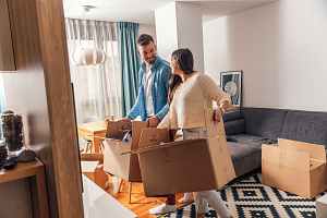 couple unpacking boxes after a move