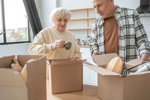 senior couple unpacking boxes after moving