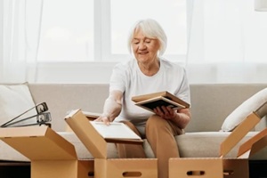 senior women unpacking after moving to a new home