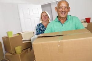 senior couple smiling during moving