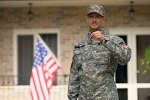 USA soldier showing keys from house, mortgage help from veterans organization