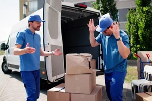 moving guys arguing over a damaged box