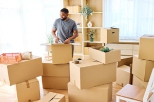 man unboxing moving boxes