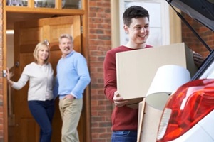 young boy maving boxes to the car