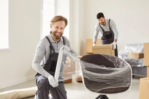 movers wrapping home furniture